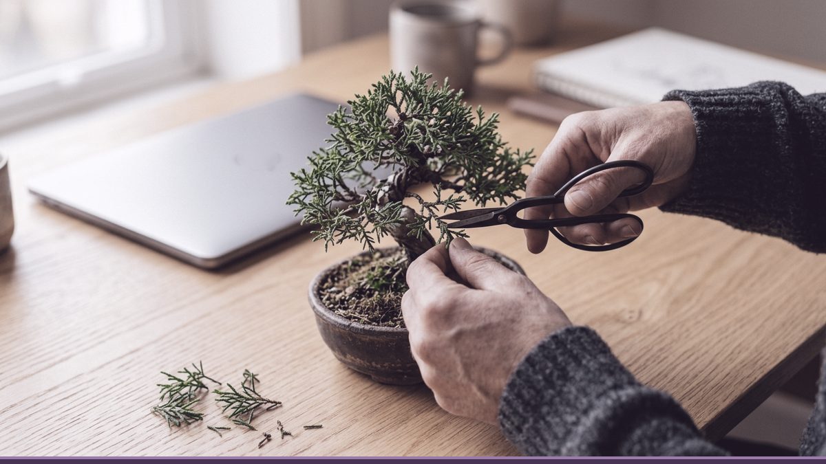 Hands pruning a bonsai tree with small scissors beside a laptop, a picture of trimming extra add-ons to keep an Elementor site fast